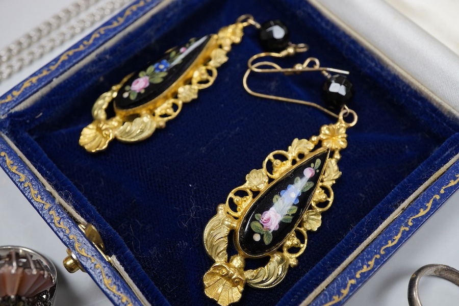 A collection of jewels, comprising: two amber pendants and an amber ring, each mounted in silver; a pair of gilt metal and enamel earrings of floral design; a pair of gilt metal earrings; a silver and cultured brooch; a
